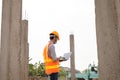 The construction site male engineer or architect is exploring and inspecting the outdoor construction site work