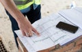 The construction site manager shows the work plan image.Construction site picture.
