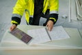 Construction site manager using digital tablet to inspect building progress. Royalty Free Stock Photo