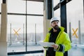 Construction site manager using digital tablet to inspect building progress. Royalty Free Stock Photo