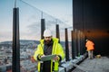 Construction site manager using digital tablet to inspect building progress. Royalty Free Stock Photo