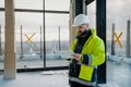 Construction site manager using digital tablet to inspect building progress. Royalty Free Stock Photo