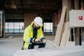 Construction site manager using digital tablet to inspect building progress. Royalty Free Stock Photo