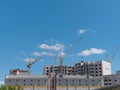 Construction site with many cranes against the sky Royalty Free Stock Photo