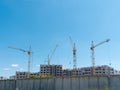 Construction site with many cranes against the sky Royalty Free Stock Photo