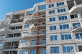 The construction site of a multi-storey residential building made of white brick against a blue sky background. View of the new Royalty Free Stock Photo