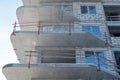 The construction site of a multi-storey residential building made of white brick against a blue sky background. View of the new Royalty Free Stock Photo