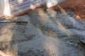 At a construction site near a new home, we are pouring wet concrete onto the driveway while it is being paved. Royalty Free Stock Photo