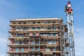 Construction site new apartment building with scaffolding and mason workers Royalty Free Stock Photo