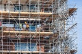 Construction site new apartment building with scaffolding and mason workers Royalty Free Stock Photo