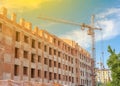 Construction site of a new apartment high building with tower cranes against blue sky. Residential area development. Real estate Royalty Free Stock Photo