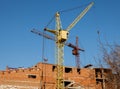 Construction site of a new apartment high building with tower cranes against blue sky. Residential area development. Real estate p Royalty Free Stock Photo