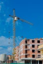 Construction site of a new apartment high building with tower cranes against blue sky. Residential area development. Real estate p Royalty Free Stock Photo