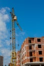 Construction site of a new apartment high building with tower cranes against blue sky. Residential area development. Real estate p Royalty Free Stock Photo