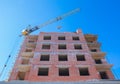 Construction site of a new apartment high building with tower cranes against blue sky. Residential area development. Real estate p Royalty Free Stock Photo
