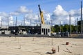 Construction site of a new industrial building, concrete block walls, columns and a telescopic crane Royalty Free Stock Photo