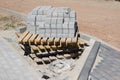 Construction site for a new road for cars. Laying paving blocks, new wells along the road.