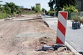 Construction site for a new road for cars. Laying paving blocks, new wells along the road.