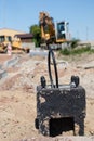 Construction site for a new road for cars. Laying paving blocks, new wells along the road.