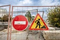 Construction site with no entry sign and caution sign in urban area during cloudy day Royalty Free Stock Photo