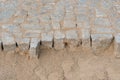 Construction site of a pavement, pile of stones and sand