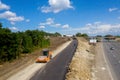 Construction site. Construction of a plant for the production of asphalt. Heavy machinery on road. Royalty Free Stock Photo