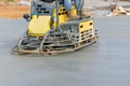 On the construction site, the process of polishing and leveling cement screed mortar floors is carried out