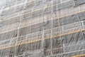 Construction site with a protective safety net on the facade of a building with scaffolding Royalty Free Stock Photo