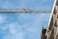 Construction site. A residential building under construction. A large tower crane is working on a building under construction. Royalty Free Stock Photo