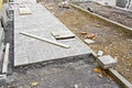 Construction site with resurfacing of a sidewalk in concrete tiles Royalty Free Stock Photo