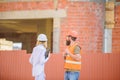 Construction site safety inspection. Discuss progress project. Safety inspector concept. Woman inspector and bearded Royalty Free Stock Photo