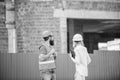Construction site safety inspection. Discuss progress project. Safety inspector concept. Woman inspector and bearded Royalty Free Stock Photo