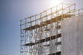 Construction site with scaffold tower and warning label building with sky background,scaffolding for construction factory