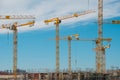 Construction site, scaffolding and many cranes on building site