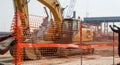 Construction Site Scene with Excavator and Safety Net being Erected Under Bright Daylight Showing Workers in Action Royalty Free Stock Photo
