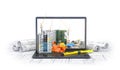 Construction site on the screen of a laptop computer, skyscraper, drawing plan, building materials
