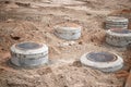 Construction site with several newly installed manhole covers surrounded by exposed soil Royalty Free Stock Photo