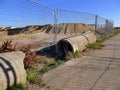 Construction site with seweragepipes for building houses surrounded with fencing