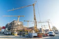 Construction site and shell construction of offices and apartment buildings with many cranes and construction vehicles Royalty Free Stock Photo