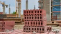 Construction Site with Stacked Red Bricks and Concrete Structure â AI Generated Content Royalty Free Stock Photo