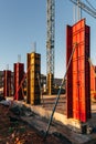 Construction site with steel formworks and reinforcing bars for pillars ready for concrete