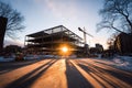 Construction site at sunset with steel structure and crane in urban environment Royalty Free Stock Photo