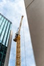 Construction site with tall cranes on background of modern office buildings city centre blue sky clouds Royalty Free Stock Photo