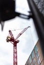 Construction site with tall cranes on background of modern office buildings city centre blue sky clouds Royalty Free Stock Photo