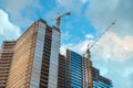 Construction site tall residetial building house by tower crane Royalty Free Stock Photo