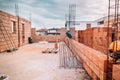 Construction site, tools, wheel barrow, sand and bricks at new house building Royalty Free Stock Photo