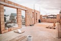 Construction site, tools, wheel barrow, sand and bricks at new house building Royalty Free Stock Photo