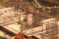 The construction site, top view. Enforced concrete steel frames rising up. The finished foundation of a building.