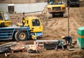 Construction site with trucks and workers on sand Royalty Free Stock Photo