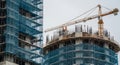 Construction Site View with Crane and Unfinished Building in Grey Sky, Housing Development and Real Estate Projects Royalty Free Stock Photo
